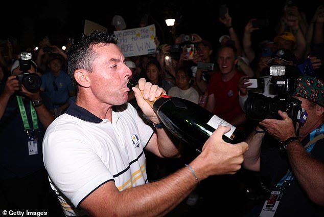 102527869-15262423-McIlroy_took_a_swig_from_a_champagne_bottle_as_the_celebrations_-a-27_1762372973919.jpg