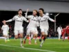 O último grito de Reid deu ao Fulham um ponto no empate de 2 a 2 com o Liverpool